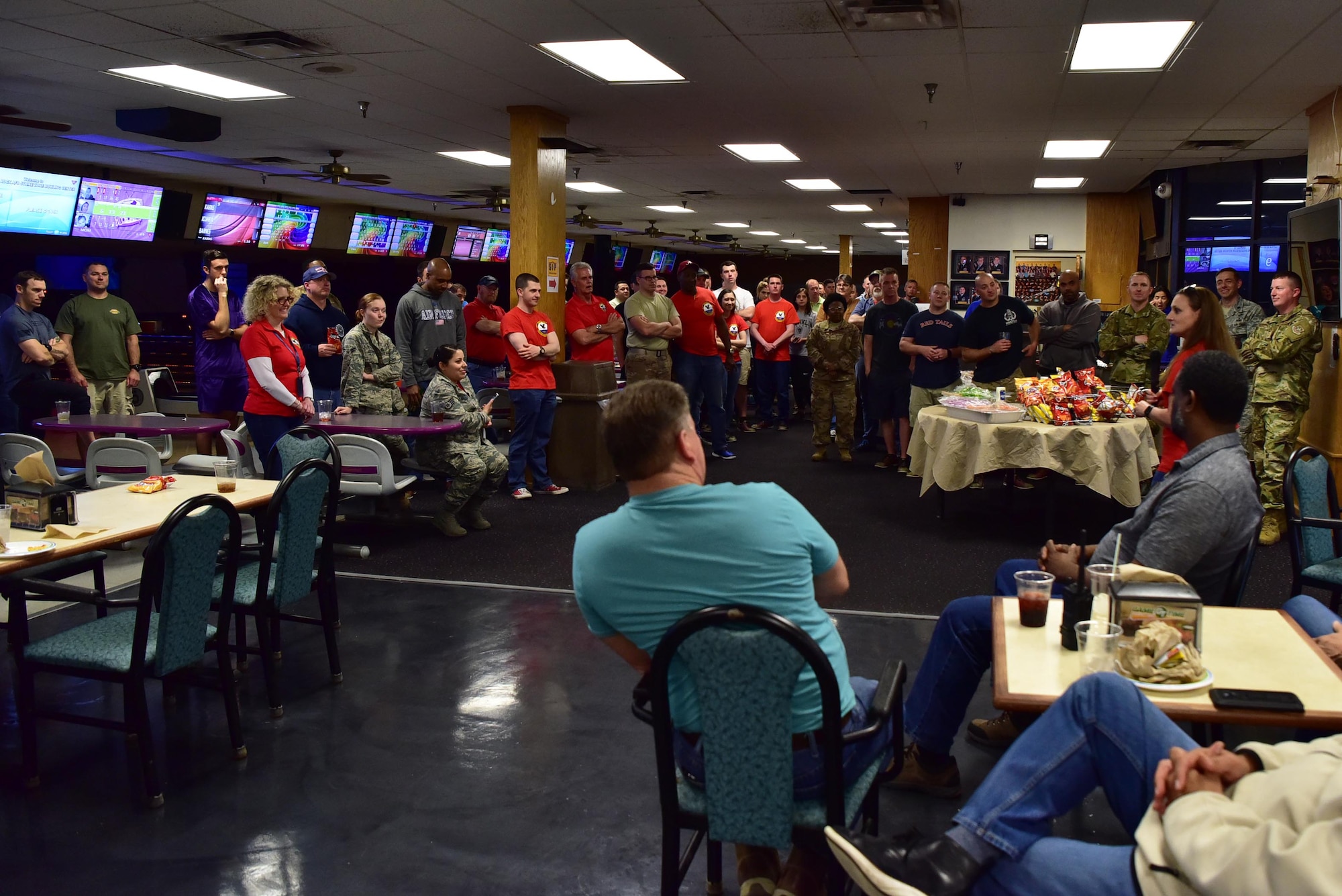 Airmen huddle at bowling alley at Little Rock Air Force Base for Unite program.