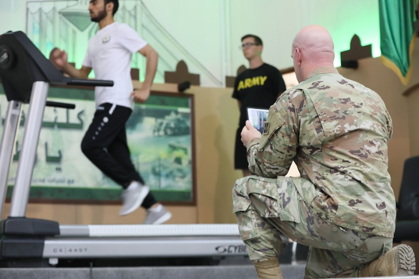 U.S. Army Capt. Anthony Williams, a physical therapist with 3rd Armored Brigade Combat Team, 4th Infantry Division, Task Force Spartan, films as a Kuwaiti volunteer runs on a treadmill during a running lecture at the Kuwait National Guard Headquarters on Tuesday, April 30, 2019. Williams presented a 90-minute lecture on proper running technique to an audience of Kuwait National Guard soldiers, new recruits, and physical trainers, in order to help soldiers run efficiently and prevent injury.