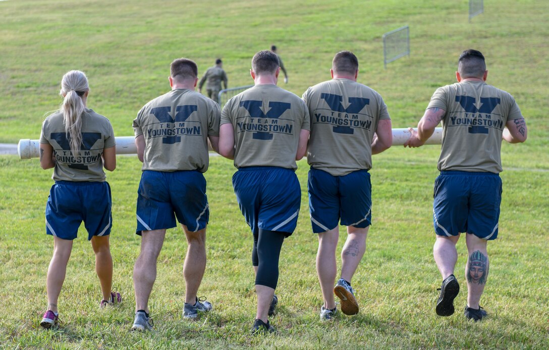 Master Sgt. Tae Choe (left), a ramp services supervisor, Master Sgt. Zach Dunkin (right), NCO in charge of load planning, and Tech. Sgt. Michael Nippers Jr. (right), all assigned to the 76th Aerial Port Squadron, tie down cargo for the pallet build-up event at the Port Dawg Challenge April 24, 2019.