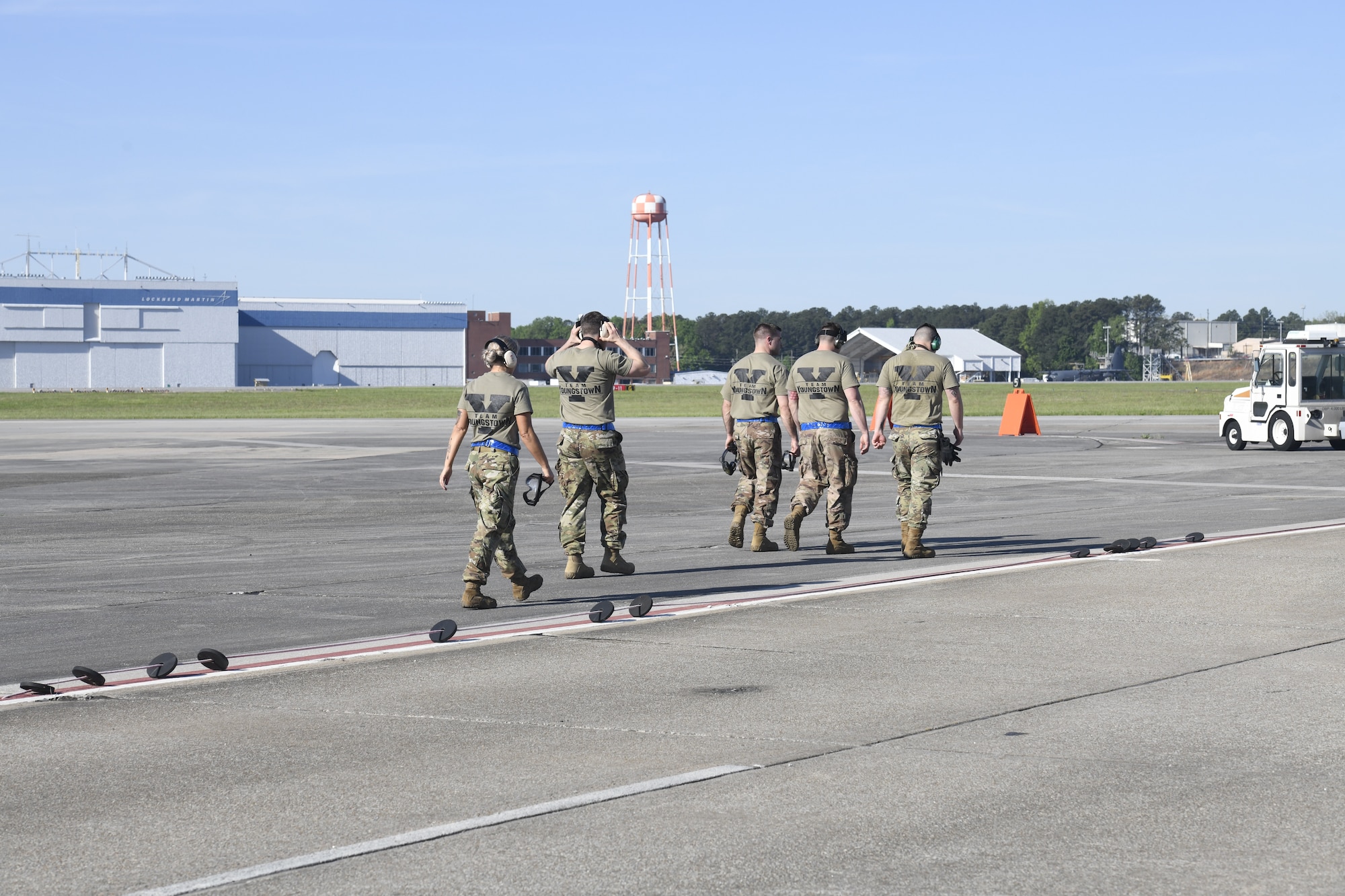 Master Sgt. Tae Choe (left), a ramp services supervisor, Master Sgt. Zach Dunkin (right), NCO in charge of load planning, and Tech. Sgt. Michael Nippers Jr. (right), all assigned to the 76th Aerial Port Squadron, tie down cargo for the pallet build-up event at the Port Dawg Challenge April 24, 2019.