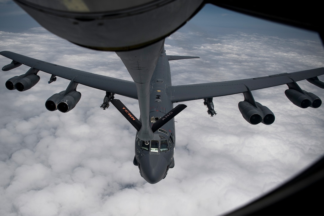 An aircraft receives fuel from another aircraft in the air.