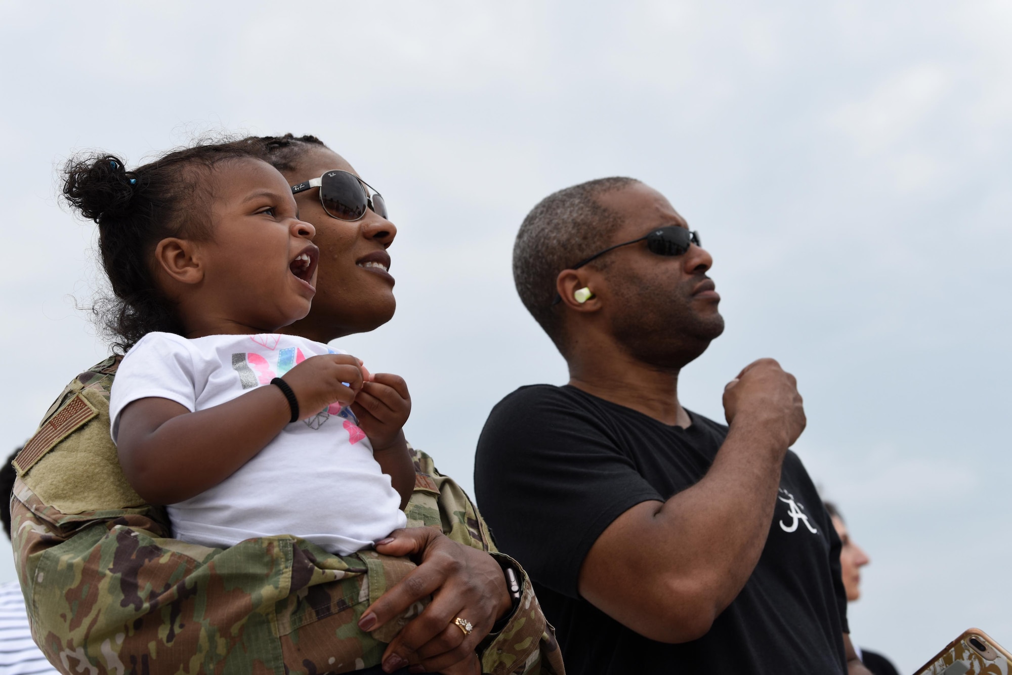 A family watches the United States Air Force Thunderbirds during the Joint Base Andrews 2019 Air and Space Expo on Joint Base Andrews, Maryland, May 11, 2019. The MQ-9 Reaper was a static display at this year’s show celebrating legends in flight over Mother’s Day weekend. (U.S. Air Force photo by Capt. Annabel Monroe)