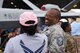 Master Sgt. Barrett, 432nd Maintenance Squadron superintendent, laughs with an attendee during the Joint Base Andrews 2019 Air and Space Expo at Joint Base Andrews, Maryland, May 11, 2019. The MQ-9 Reaper was a static display at this year’s show celebrating legends in flight. (U.S. Air Force photo by Airman 1st Class Haley Stevens)