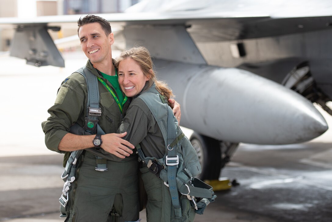 Capt. Kyle Moses, 310th Fighter Squadron instructor pilot, receives a hug from his sister Capt. Kaleigh Moses, 56th Medical Operations Squadron nurse practitioner, before flying in the backseat of an F-16D Fighting Falcon at Luke Air Force Base, Ariz., May 10, 2019. Kaleigh flew alongside her sibling during a familiarization flight where she not only saw what her brother does as an instructor pilot, but was able to see how her job facilitates the training. (U.S. Air Force photo by Staff Sgt. Jensen Stidham)