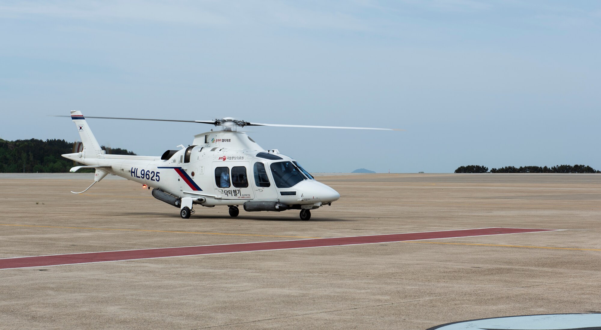 A helicopter from Wonkwang University Medical Center lands to pick up a simulated patient at Kunsan Air Base, Republic of Korea, May 8, 2019. The 8th Medical Group coordinated with Wonkwang to test out an emergency medical flight transporting a patient from Kunsan Air Base to the hospital in Iksan. (U.S. Air Force photo by Senior Airman Stefan Alvarez)