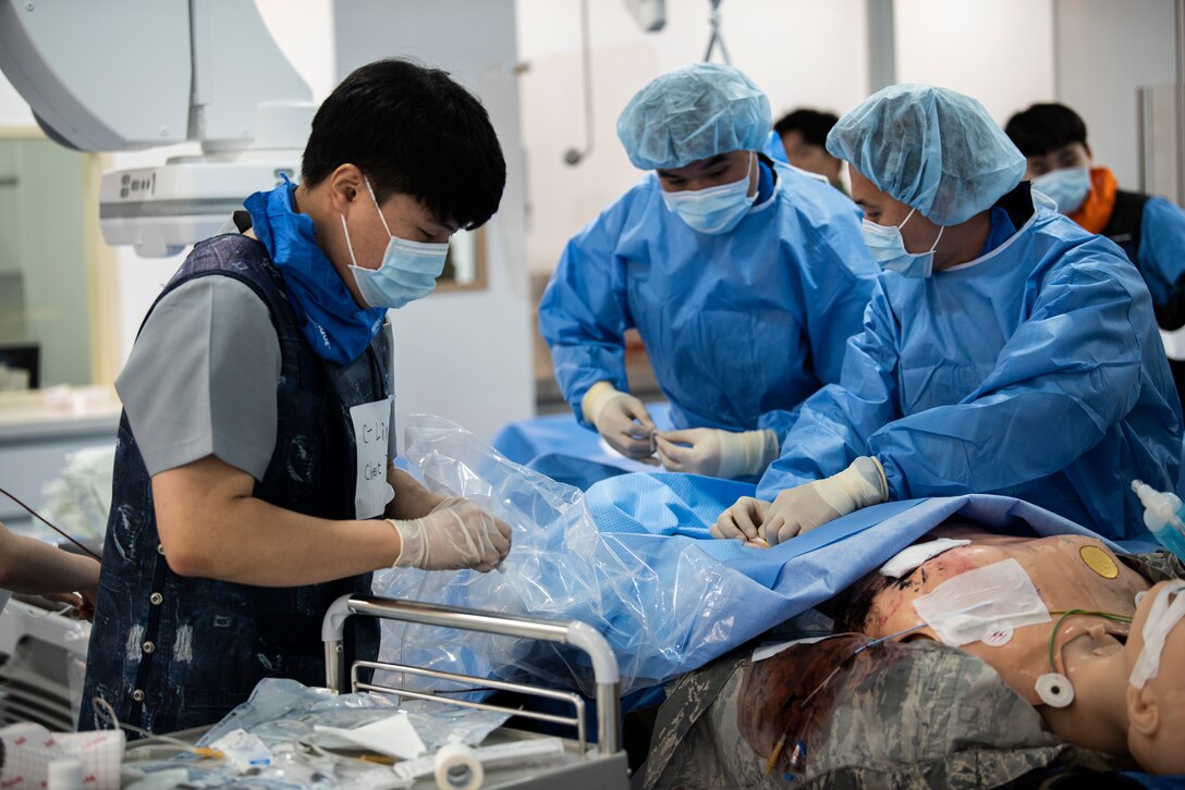 Medical staff perform surgery on a simulated patient at Wonkwang University Medical Center, Republic of Korea, May 8, 2019. The 8th Medical Group worked with the staff at Wonkwang to test the viability of picking up a casualty at Kunsan Air Base and bringing them to the medical center for emergency surgery to expedite care. (U.S. Air Force photo by Senior Airman Stefan Alvarez)