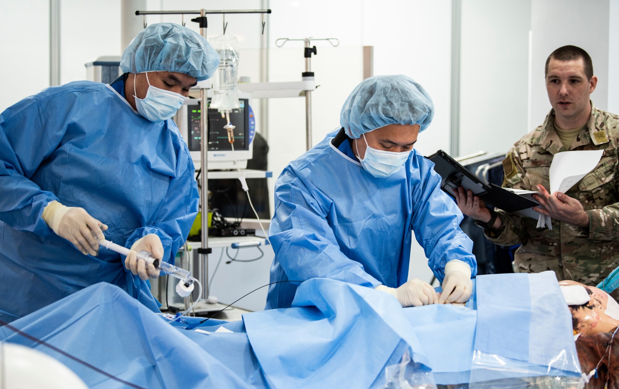 U.S. Air Force Tech. Sgt. Adam Tarbill (right), 8th Medical Operations Squadron flight medicine flight chief, observes medical staff perform surgery on a simulated patient at Wonkwang University Medical Center, Republic of Korea, May 8, 2019. The 8th Medical Group coordinated with Wonkwang to test out an emergency medical flight transporting a patient from Kunsan Air Base to the hospital in Iksan. (U.S. Air Force photo by Senior Airman Stefan Alvarez)