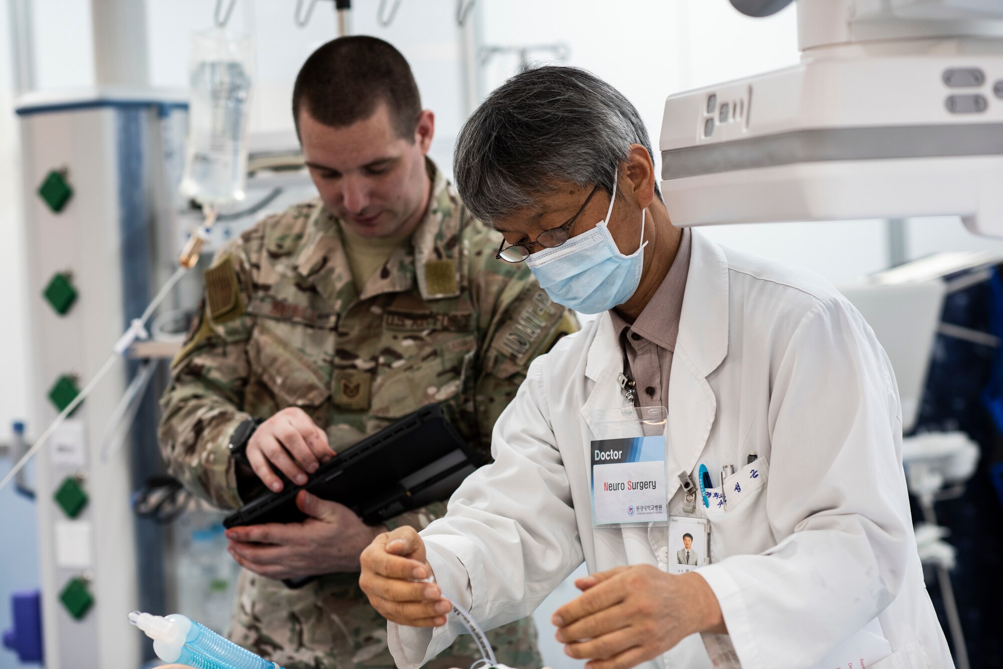 U.S. Air Force Tech. Sgt. Adam Tarbill (left), 8th Medical Operations Squadron flight medicine flight chief, monitors vital signs on a simulated patient at Wonkwang University Medical Center, Republic of Korea, May 8, 2019. The 8th Medical Group coordinated with Wonkwang to test out an emergency medical flight transporting a patient from Kunsan Air Base to the hospital in Iksan. (U.S. Air Force photo by Senior Airman Stefan Alvarez)