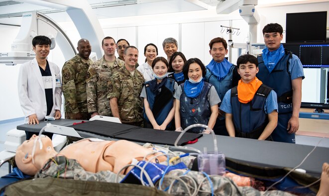Leadership from the 8th Medical Group pose for a photo with medical staff at Wonkwang University Medical Center, Republic of Korea, May 8, 2019. The surgical team at Wonkwang successfully performed a life-saving operation on a simulated patient transported via helicopter from Kunsan Air Base, paving the way for a continued relationship between the medical center and Kunsan. (U.S. Air Force photo by Senior Airman Stefan Alvarez)