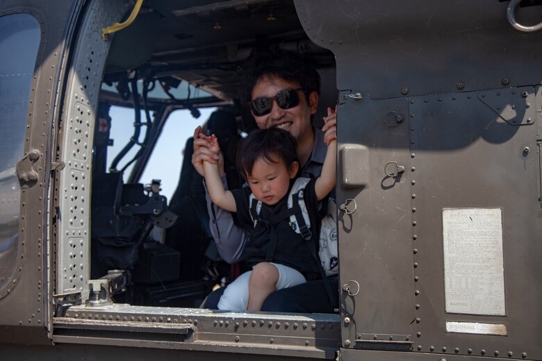 Local community members pose for a photo in the aircraft static display for the Friendship Festival May 11, 2019, on Combined Arms Training Center Camp Fuji, Shizuoka, Japan.
