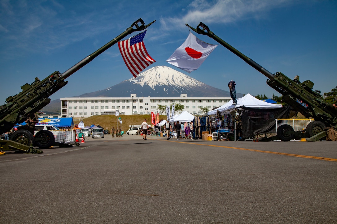 The Japan and U.S. flags hang on display from M777A2 lightweight 155 mm howitzers during the Friendship Festival May 11, 2019, on Combined Arms Training Center Camp Fuji, Shizuoka, Japan.