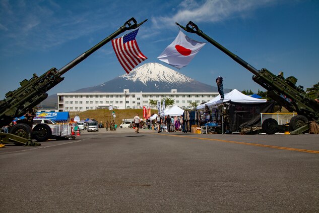 The Japan and U.S. flags hang on display from M777A2 lightweight 155 mm howitzers during the Friendship Festival May 11, 2019, on Combined Arms Training Center Camp Fuji, Shizuoka, Japan.