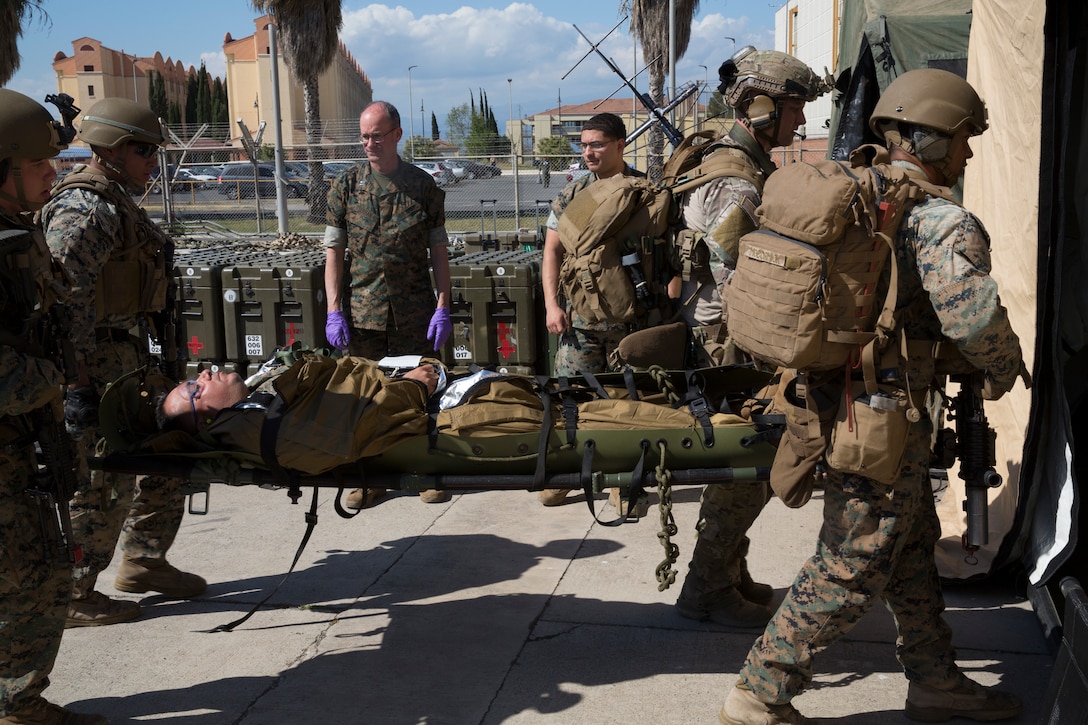 U.S. Marines with the Special Purpose Marine Air-Ground Task Force-Crisis Response-Africa 19.2, Marine Forces Europe and Africa,  transport a simulated casualty into a field-medical facility during a full-mission profile rehearsal at Naval Air Station Sigonella, Italy, May 2, 2019. SPMAGTF-CR-AF 19.2 conducted a full-mission profile rehearsal to increase proficiency and decrease crisis-response time for contingencies. SPMAGTF-CR-AF is deployed to conduct crisis-response and theater-security operations in Africa and promote regional stability by conducting military-to-military training exercises throughout Europe and Africa. (U.S. Marine Corps photo by Staff Sgt. Mark E Morrow Jr.)