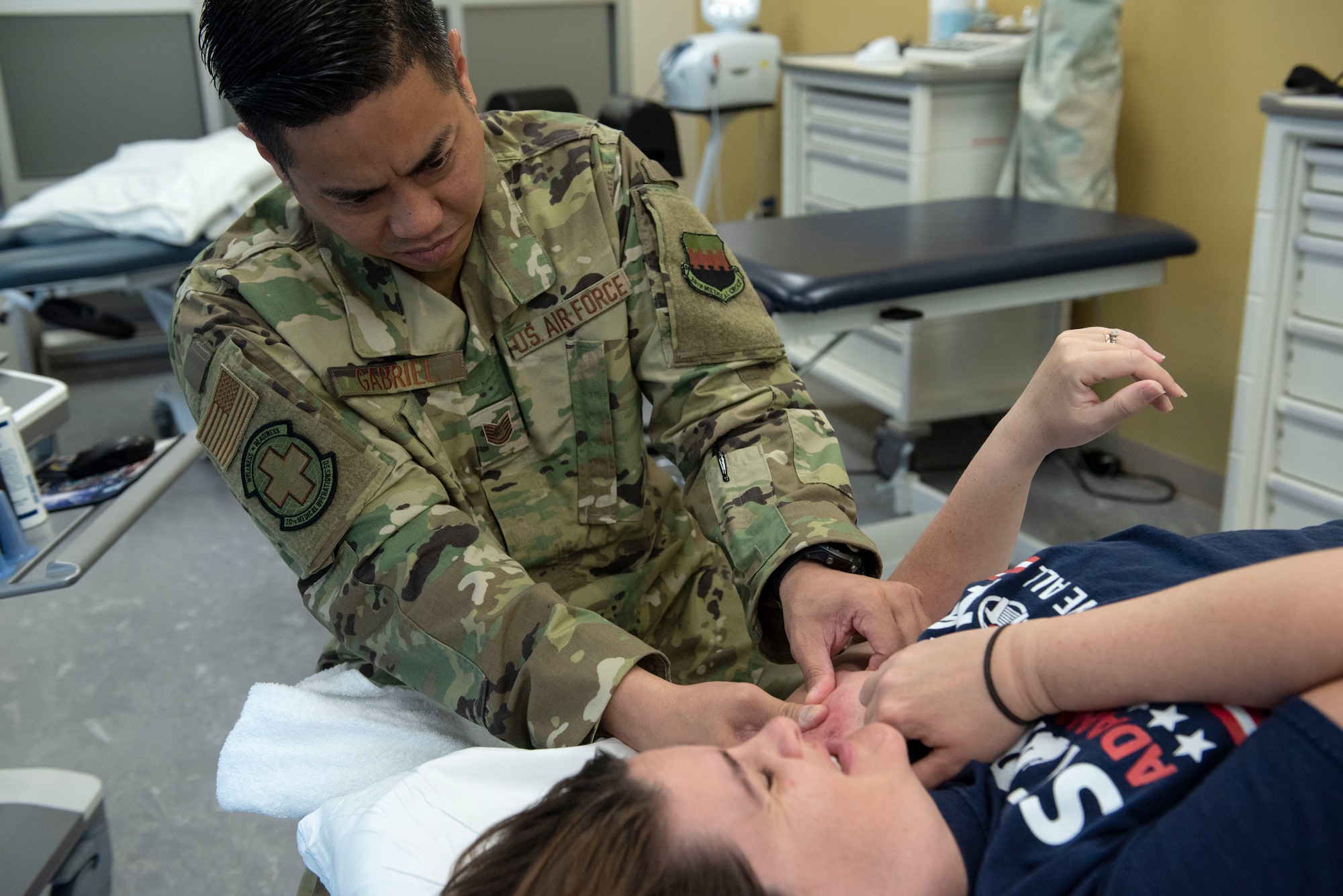 U.S. Air Force Tech. Sgt. Phillip Gabriel, 20th Medical Operations Squadron physical therapy clinic flight chief, massages scar tissue on the shoulder of Master Sgt. Sunny Downes, 20th Component Maintenance Squadron fuels systems repair assistant section chief, at Shaw Air Force Base, S.C., May 10, 2019.