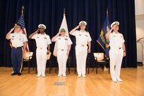 Capt. Cedric McNeal (second from left) relieves Capt. Mark Vandroff (second from right) as the commanding officer of Naval Surface Warfare Center, Carderock Division in a ceremony May 3, 2019, in the Maritime Technology Information Center at Carderock Division in West Bethesda, Md. From left, Col. Laurence Bazer, deputy director for the Office of the National Guard, Joint Chaplains Office; McNeal; Capt. Andy Arnold, chief of staff, Naval Surface and Undersea Warfare Center; Vandroff; Rear Adm. William Galinis, Program Executive Officer, Ships. (U.S. Navy photo by Nicholas Brezzell/Released)