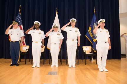 Capt. Cedric McNeal (second from left) relieves Capt. Mark Vandroff (second from right) as the commanding officer of Naval Surface Warfare Center, Carderock Division in a ceremony May 3, 2019, in the Maritime Technology Information Center at Carderock Division in West Bethesda, Md. From left, Col. Laurence Bazer, deputy director for the Office of the National Guard, Joint Chaplains Office; McNeal; Capt. Andy Arnold, chief of staff, Naval Surface and Undersea Warfare Center; Vandroff; Rear Adm. William Galinis, Program Executive Officer, Ships. (U.S. Navy photo by Nicholas Brezzell/Released)