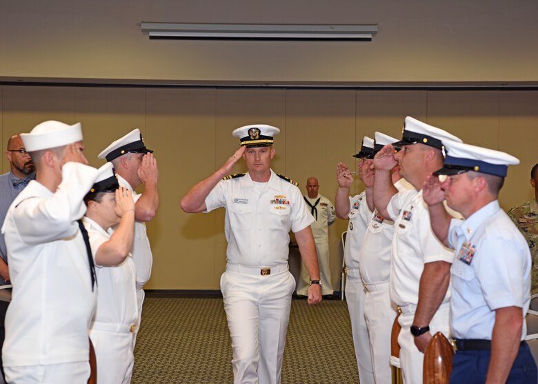 U.S. Navy Lt. Cmdr. J. Austin Maxwell, Center for Information Warfare Training detachment Goodfellow officer in charge, exchanges salutes with the seamen during the arrival of the official party at the event center on Goodfellow Air Force Base, Texas, May 9, 2019. The boatswains whistle was used to alert the crew of the arrival of the official party. (U.S. Air Force photo by Airman 1st Class Ethan Sherwood/Released)