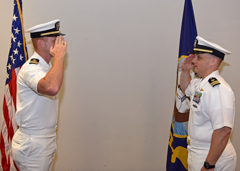 U.S. Navy Lt. Cmdr. J. Austin Maxwell, Center for Information Warfare Training detachment Goodfellow officer in charge, exchanges salutes with Lt. Cmdr. John Allen, departing CIWT detachment Goodfellow commanding officer, during the change of charge ceremony at the event center on Goodfellow Air Force Base, Texas, May 9, 2019. The change of charge ceremony is a time honored military tradition that signifies the visual transfer of authority. (U.S. Air Force photo by Airman 1st Class Ethan Sherwood/Released)