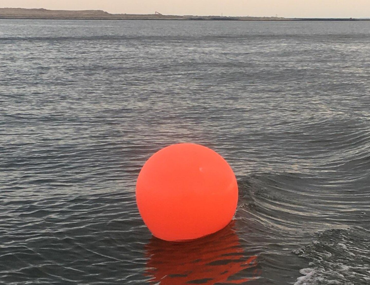 An orange ball buoy is shown to warn boaters of the navigation hazards located within the construction zone off of Poplar Island. This construction is part of Baltimore District’s Poplar Island expansion project, which is a partnership with the Maryland Port Administration, to create an additional 575 acres of remote island habitat using clean material dredged from the Maryland Chesapeake Bay approach channels to the Port of Baltimore.