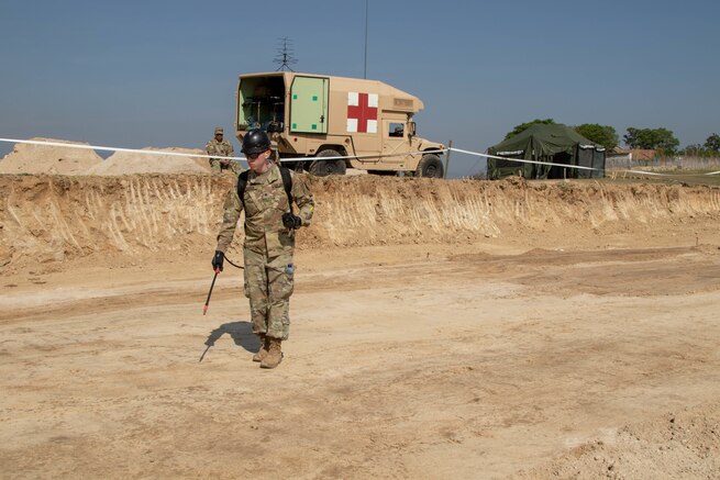 A U.S. Army Soldier sprays the ground prior to compaction at the Aldea Eucalypto school construction site in Huehuetenango, Guatemala.