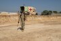 A U.S. Army Soldier sprays the ground prior to compaction at the Aldea Eucalypto school construction site in Huehuetenango, Guatemala.