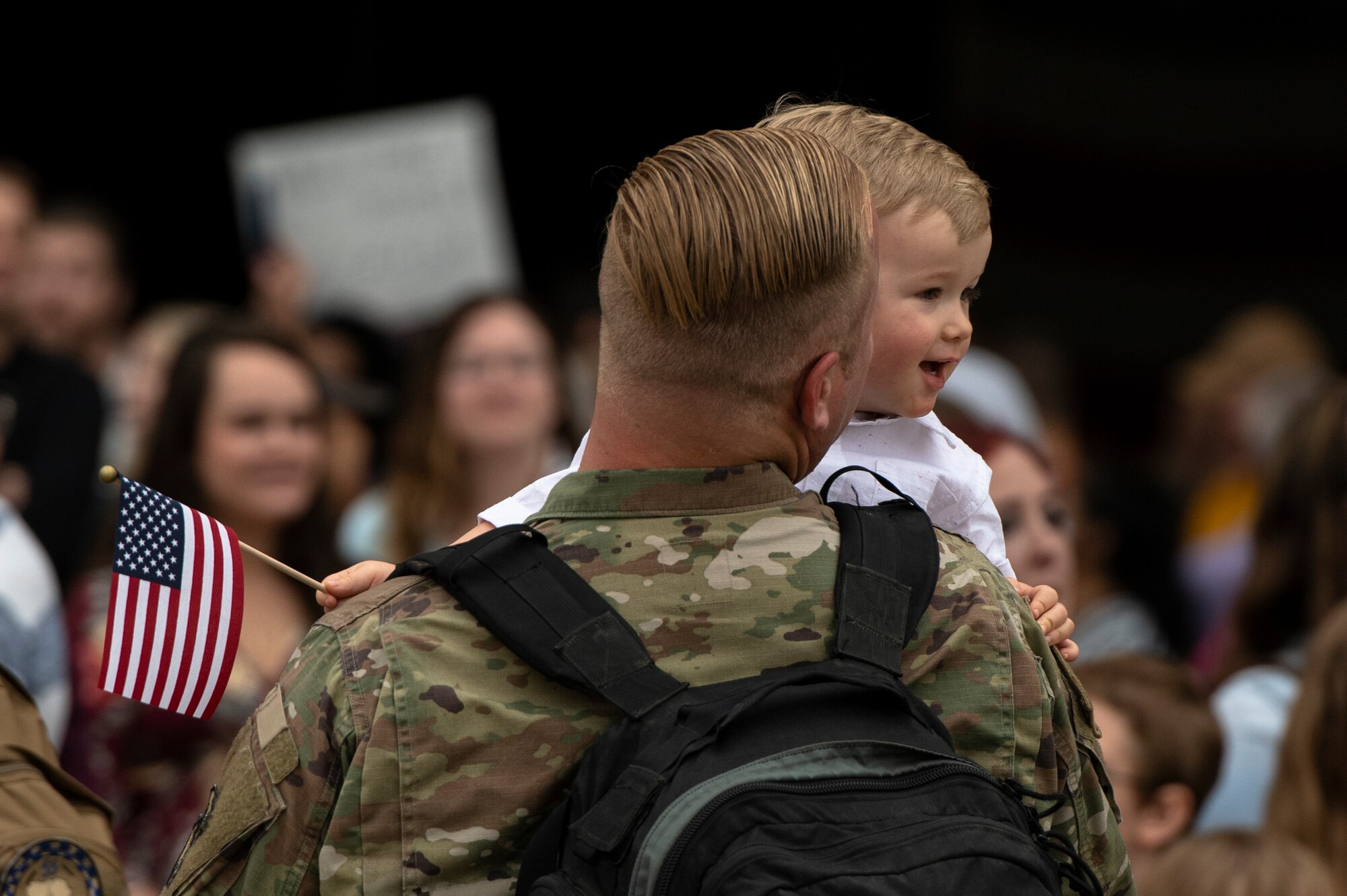 U.S. Air Force Tech. Sgt. Austin Gorbet, 20th Aircraft Maintenance Squadron weapon load crew chief, embraces his son after returning from a deployment to an undisclosed location in Southwest Asia to Shaw Air Force Base, S.C., May 4, 2019.