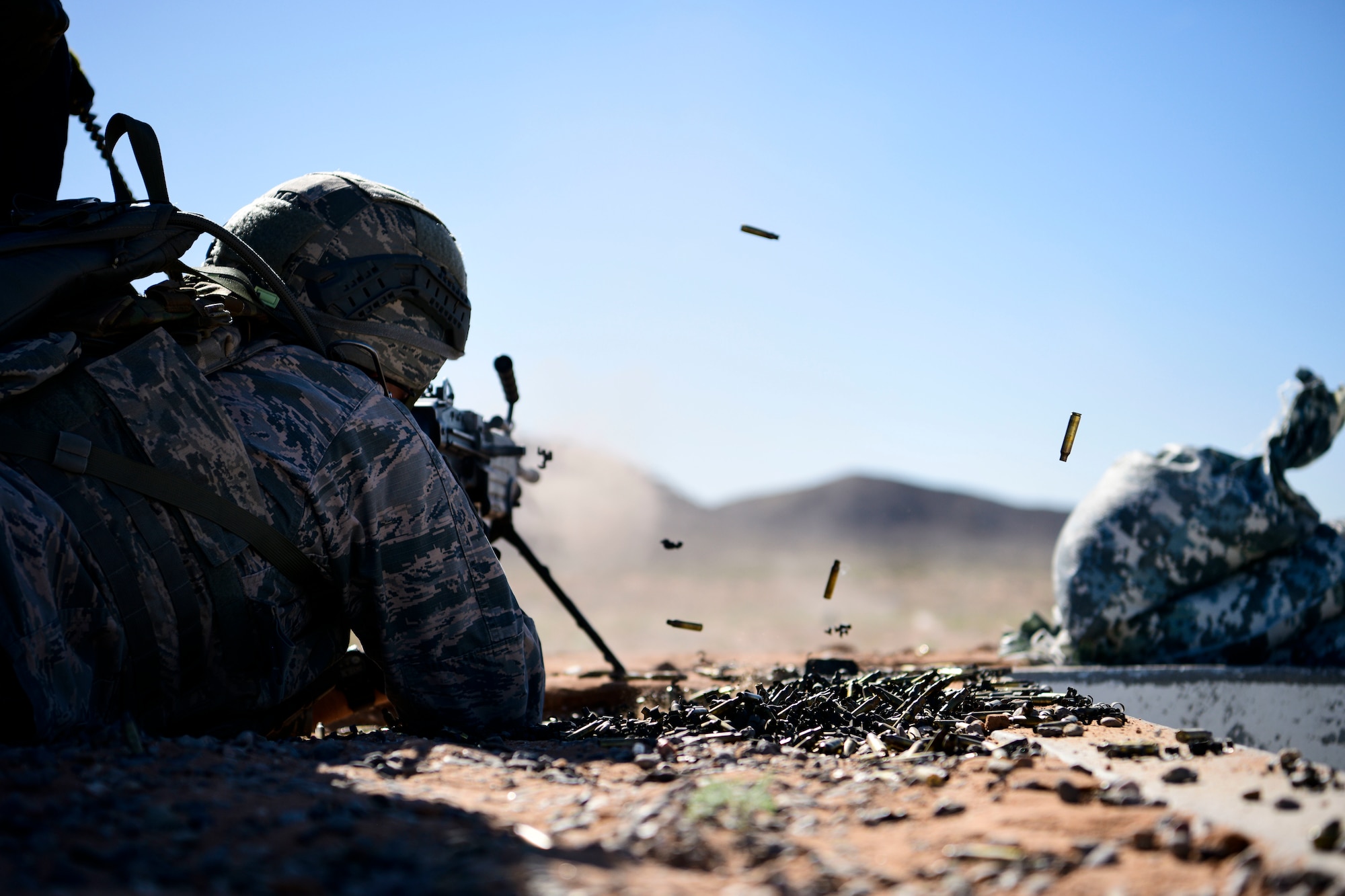 An Airman participating in the Combat Support Wing exercise shoots an M249 machine gun, May 1, 2019, at Fort Bliss, Texas. Airmen trained for the CSW concept by participating in various exercises such as flightline maintenance and operations, security, and other combat support functions. (U.S. Air Force photo by Senior Airman Kenneth Boyton)