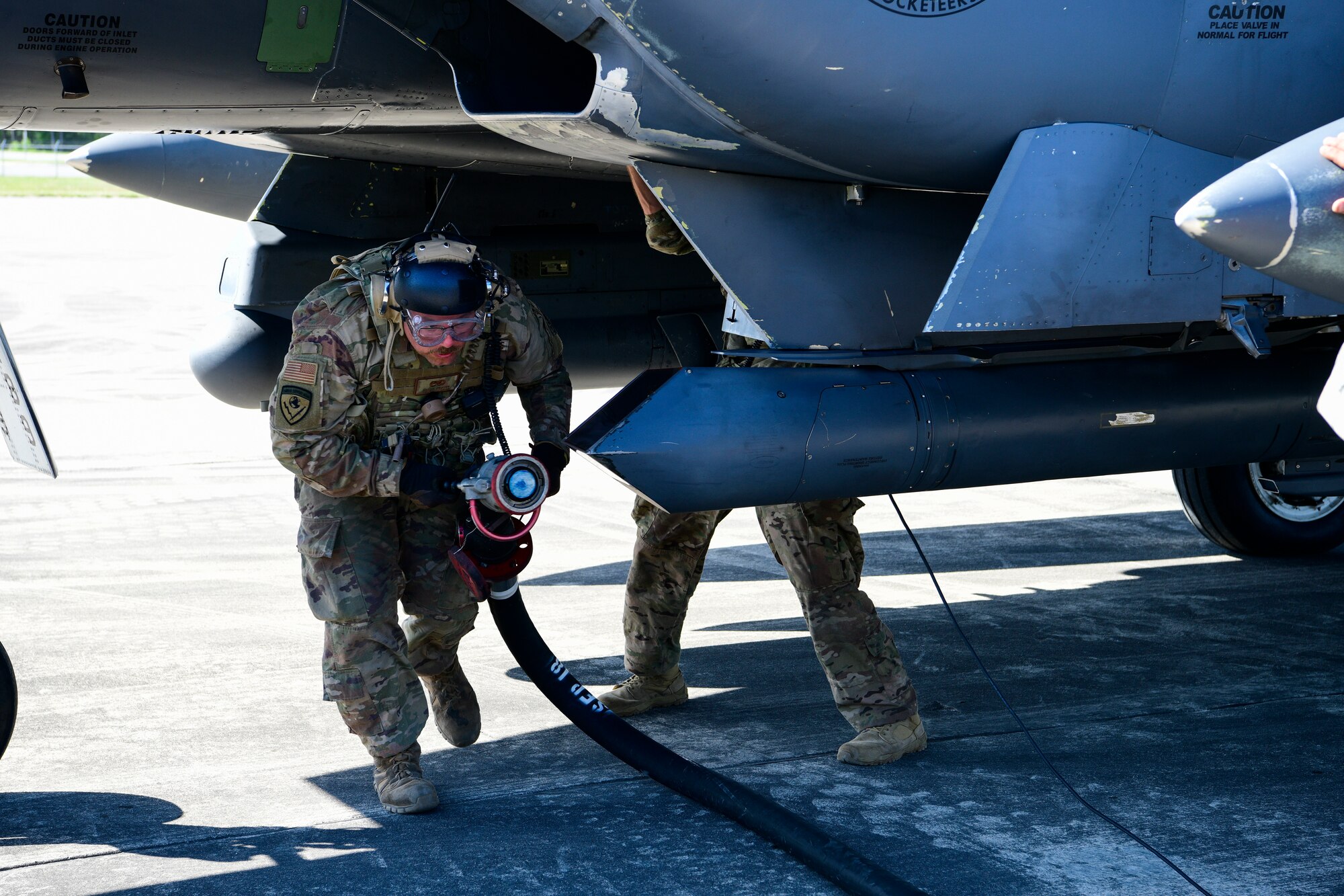 Staff Sgt. Shane Frayer, 4th Equipment Maintenance Squadron crash and recovery craftsman, performs a hot-pit refuel for an F-15E Strike Eagle during the Combat Support Wing capstone, May 9, 2019, at Kinston Regional Jetport, North Carolina. The CSW provides multifunctional training for Airmen to rapidly deploy in smaller, more efficient and agile teams, effectively creating a smaller footprint in dangerous or non-permissive areas. (U.S. Air Force photo by Senior Airman Kenneth Boyton)