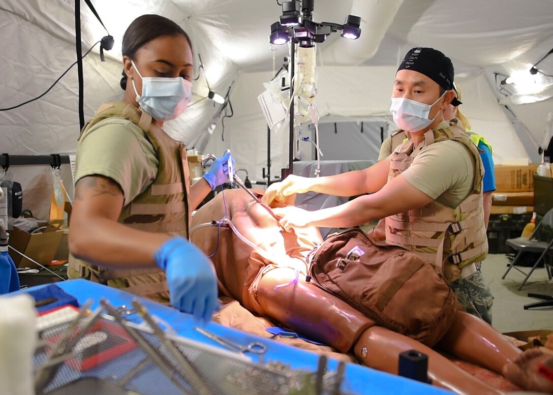 Players in the Expeditionary Medical Support exercise operate on a mannequin, May 9, 2019 at Joint Base Langley-Eustis, Virginia.