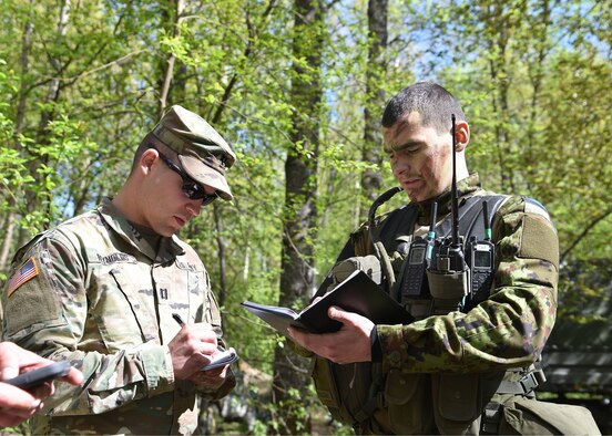 Army Capt. Timothy Reynolds, commander of the 290th Military Police Company, Maryland National Guard, speaks with 1st Lt. Mart Sildnik, company commander of 1st Infantry Brigade military police, Estonian Defense Force, during the Spring Storm exercise, May 6, 2019, in Ida-Viru County, Estonia. Spring Storm is an Estonian Defense Force annual exercise that fosters collaboration between Estonia, the United States, Poland, Britain, Canada and other participating allied nations.