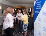 People talk during a break at the Global Housing Symposium in San Antonio May 7. The three-day event focused on improving the Air Force privatized housing program to meet the needs of Airmen and their families.