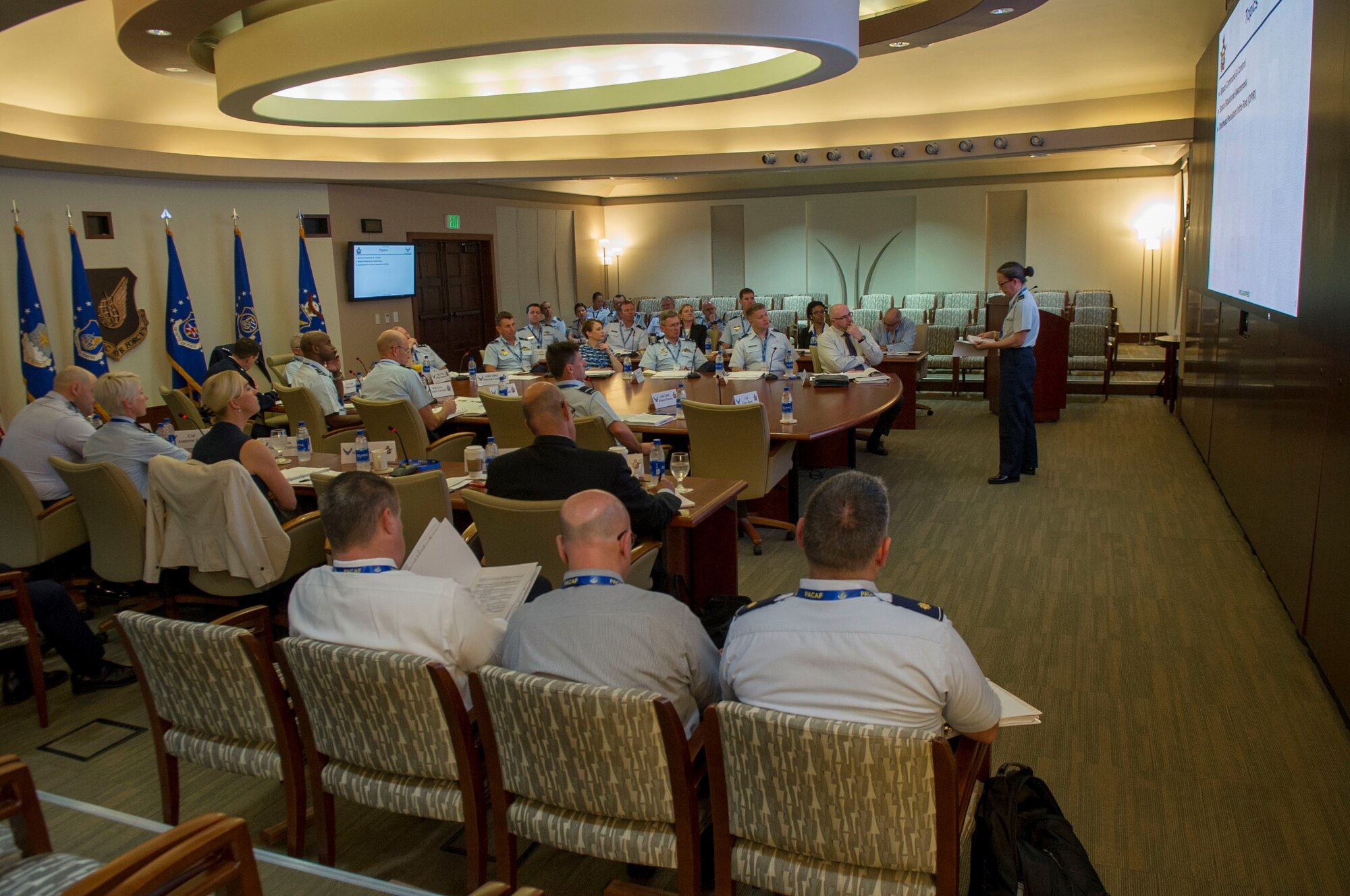 U.S. Air Force Col. Jean Eisenhut, assigned to U.S. Air Force Space Command, gives a briefing during the Air Senior National Representatives meeting at Headquarters Pacific Air Forces, Joint Base Pearl Harbor-Hickam, Hawaii, May 9, 2019.