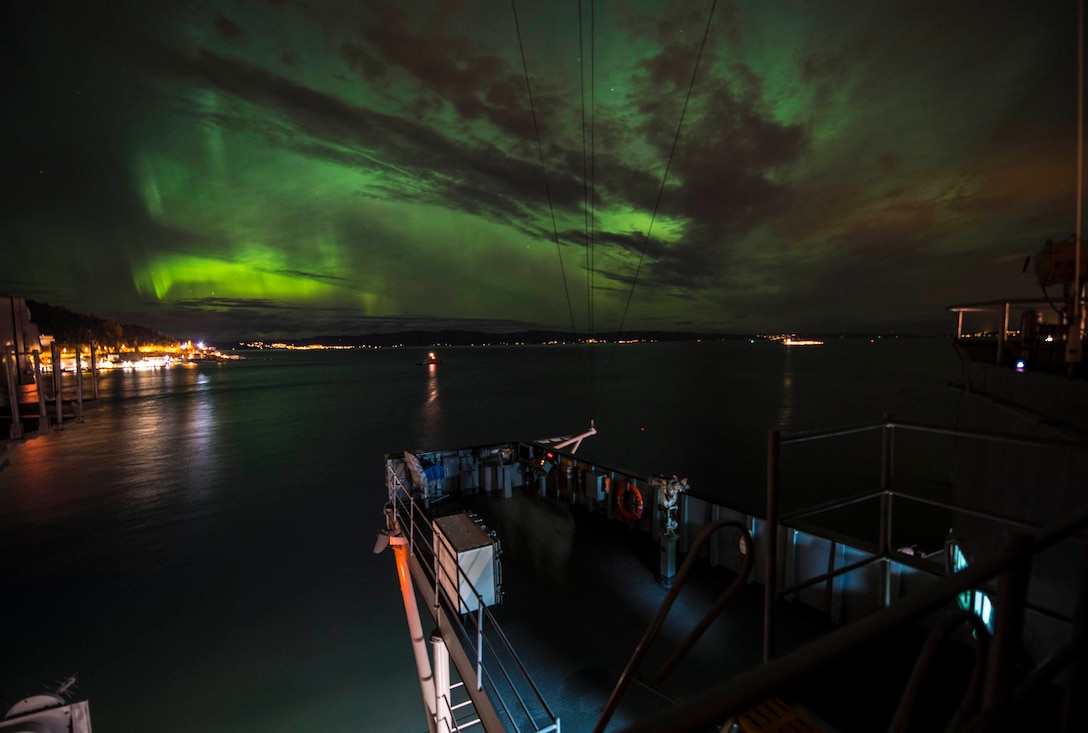 USS Mount Whitney, moored under northern lights in Trondheim, Norway, November 4, 2018, during multilateral exercise Trident Juncture 18 (U.S. Navy/James R. Turner)