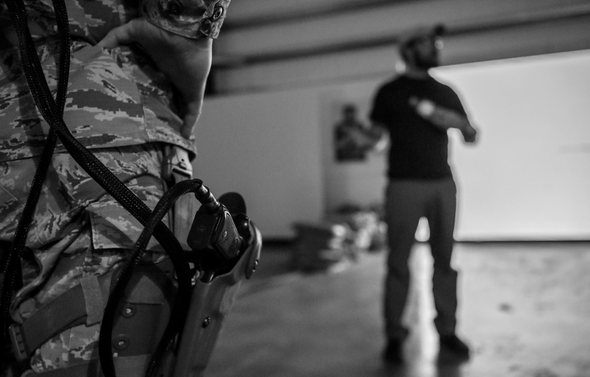 U.S. Army Bryan Reed, Warrior Training Alliance instructor, explains to 627th Security Forces Squadron (SFS) Airmen the process for training with a simulator that puts the defenders through various scenarios to test them on use of force and other tactics at Joint Base Lewis-McChord, Wash., April 30, 2019. The Warrior Training Alliance is just one of several opportunities the 627th SFS can take advantage of as a part of the Reconstitute Defender Initiative that was implemented by top Air Force leaders. (U.S. Air Force photo by Senior Airman Tryphena Mayhugh)