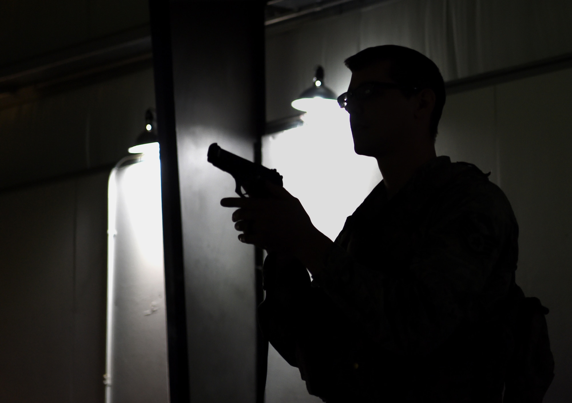 U.S. Air Force Staff Sgt. Chad Rogers, 627th Security Forces Squadron (SFS) noncommissioned officer in charge of plans and programs, removes his weapon during a simulated active-shooter training scenario at Joint Base Lewis-McChord, Wash., April 30, 2019.  Top Air Force leaders declared 2019 as the Year of the Defender, initiating the Reconstitute Defender Initiative to revitalize the security forces squadron across the Air Force. As a part of this, the 627th SFS has worked to increase their time using the U.S. Army’s urban-response simulator for training. (U.S. Air Force photo by Senior Airman Tryphena Mayhugh)