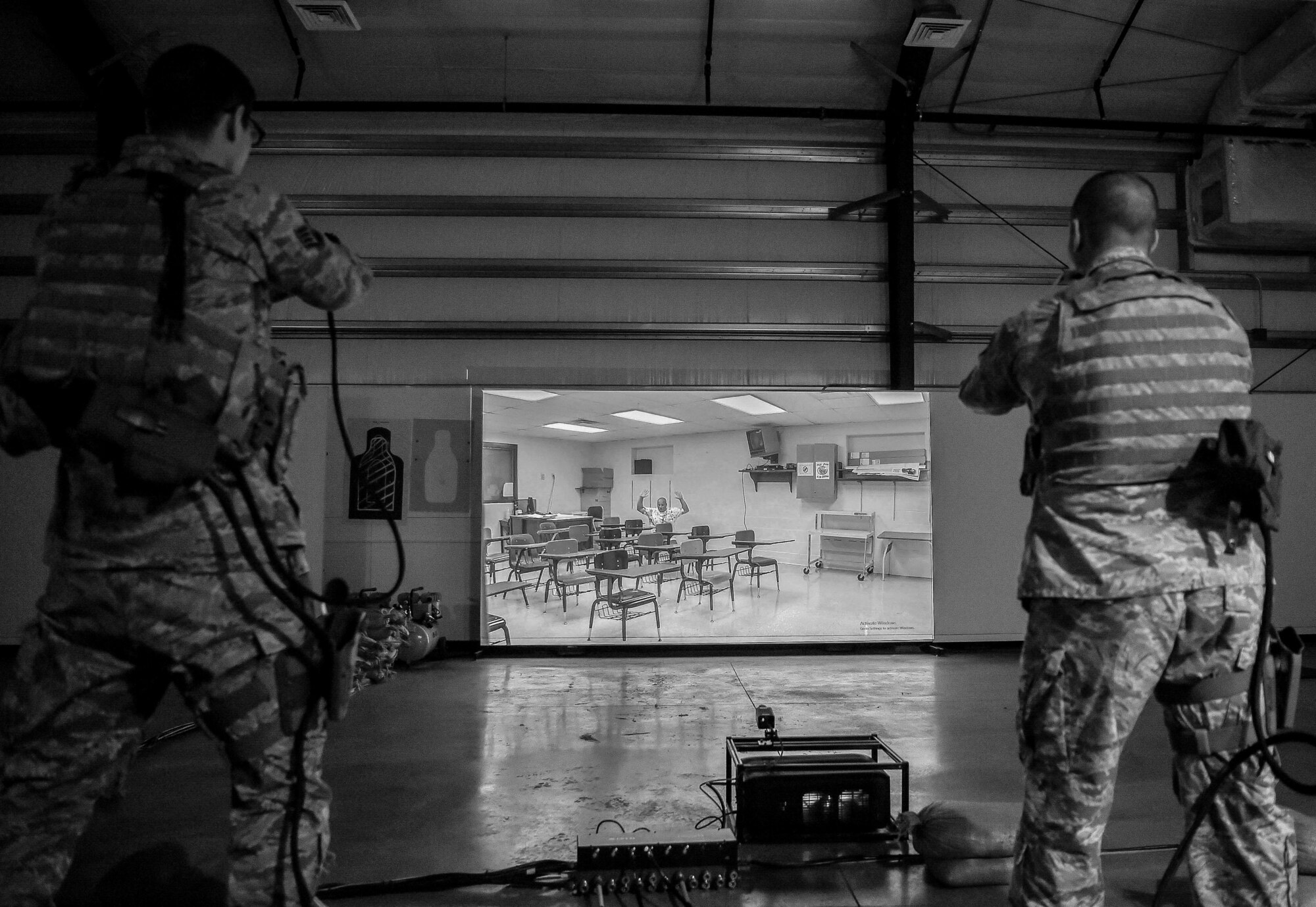 During simulated training at Joint Base Lewis-McChord, Wash., U.S. Air Force Staff Sgt. Chad Rogers, 627th Security Forces Squadron (SFS) noncommissioned officer in charge of plans and programs, and U.S. Air Force Staff Sgt. Kenneth Daugherty, 627th SFS base defense operations controller, orders an active shooter to get on his knees, April 30, 2019. Increased training, equipment upgrades and more were implemented across the 627th SFS as a part of the Reconstitute Defender Initiative to revitalize security forces squadrons across the Air Force. (U.S. Air Force photo by Senior Airman Tryphena Mayhugh)