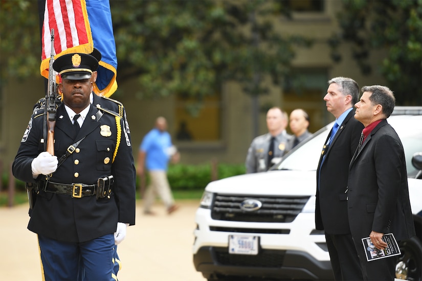 Police officers carry an array of flags.