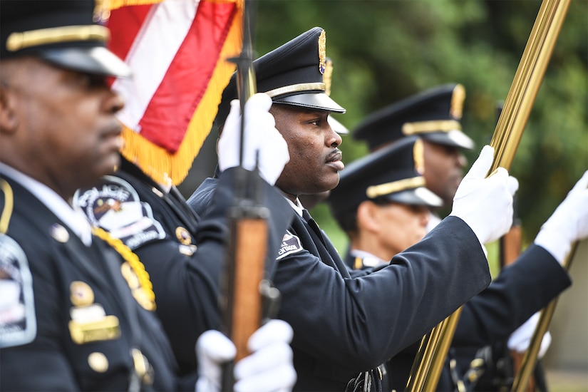 Police officers carry an array of flags.