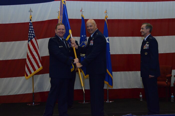 Maj. Gen. Brian K. Borgen receives the Tenth Air Force Flag from Lt. Gen. Richard Scobee, signifying accepts command of Tenth Air Force during the Change of Command ceremony May 10, at Naval Air Station Fort Worth Joint Reserve Base, Texas