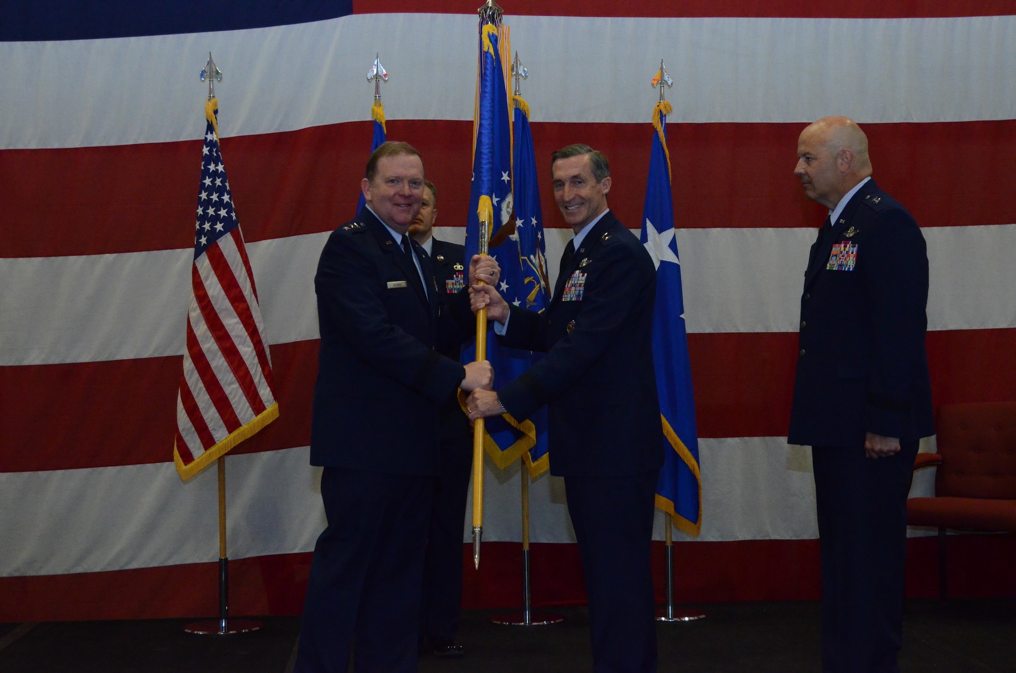 Maj. Gen. Ronald B. "Bruce" Miller returns the flag to Lt. Gen. Richard W. Scobee, signifying the end of his time as Tenth Air Force Commander during the Tenth Air Force Change of Command ceremony, May 10, at Naval Air Station Fort Worth Joint Reserve Base, Texas