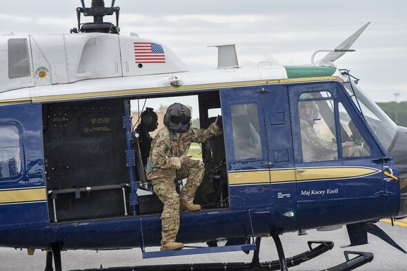 U.S. Air Force Technical Sgt. Joshua Lucas, 1st Helicopter Squadron flight engineer, prepares for flight in a UH-1 Huey during the opening ceremonies at the Joint Base Andrews Air & Space Expo, May 10. (U.S. Air Force photo by 2nd Lt. Jessica Cicchetto)