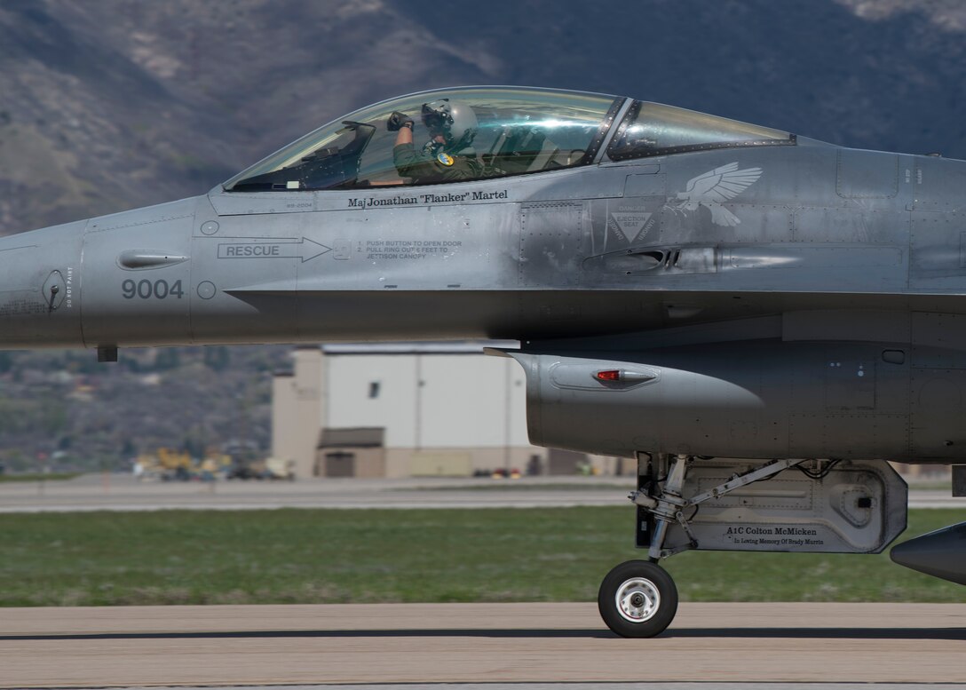 A 311th Fighter Squadron F-16 Viper pilot displays the squadron “Fangs Out” symbol while taxiing after takeoff, April 24, 2019, on Hill Air Force Base, Utah. Between April 22 and May 3, the 311th FS conducted 174 sorties in support of student pilot training and dissimilar air combat training with the F-35 Lightning II. (U.S. Air Force photo by Staff Sgt. BreeAnn Sachs)