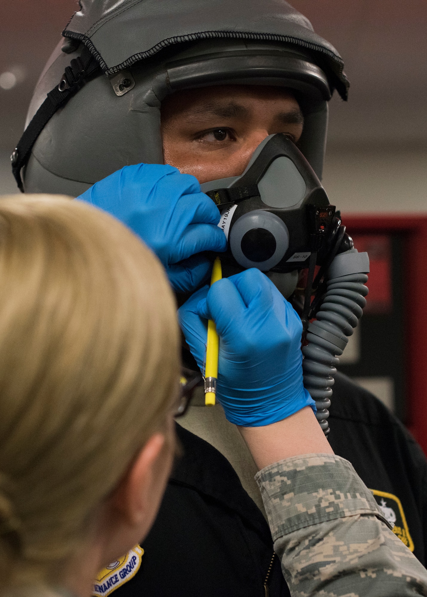 Airman 1st Class Kaci Ashby, 54th Operations Support Squadron Aircrew Flight Equipment technician, fits a flight mask for Staff Sgt. Alfredo Contreas, 311th Aircraft Maintenance Unit Dedicated Crew Chief, April 24, 2019, on Hill Air Force Base, Utah. Forty operations and maintenance personnel were given familiarization flights in F-16 Vipers during exercise Venom 19-01. (U.S. Air Force photo by Staff Sgt. BreeAnn Sachs)