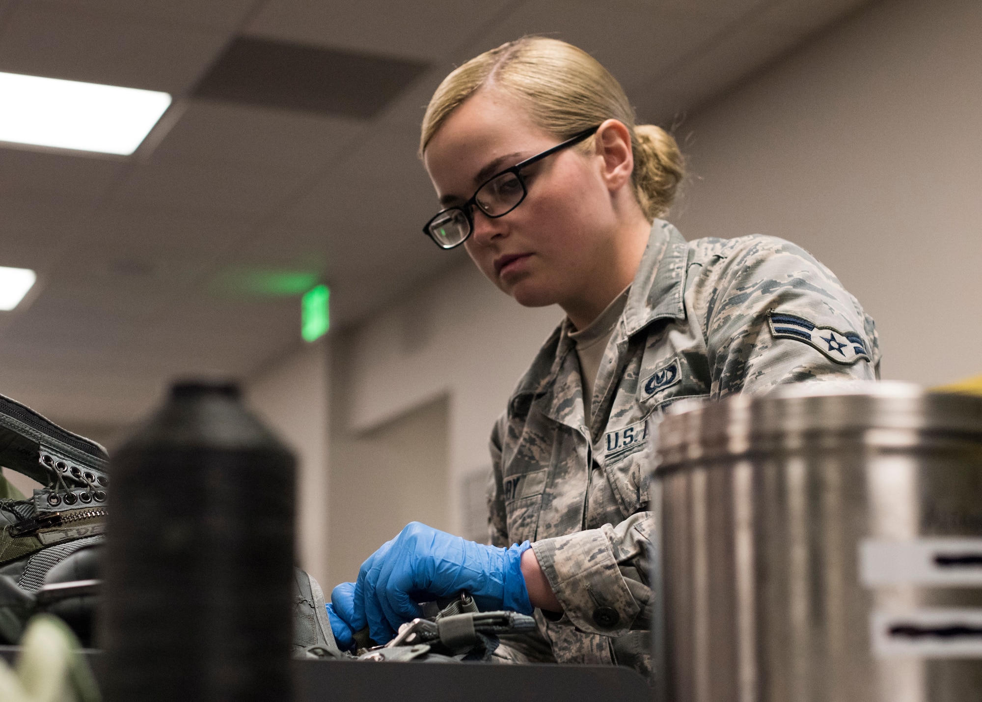 Airman 1st Class Kaci Ashby, 54th Operations Support Squadron Aircrew Flight Equipment technician, tapes a strap on a Life Preserver Unit, April 24, 2019, on Hill Air Force Base, Utah. Pilots with the 311th Fighter Squadron had the opportunity to fly over water during exercise Venom 19-01, and required specialized equipment in the event of an ejection over water. (U.S. Air Force photo by Staff Sgt. BreeAnn Sachs)