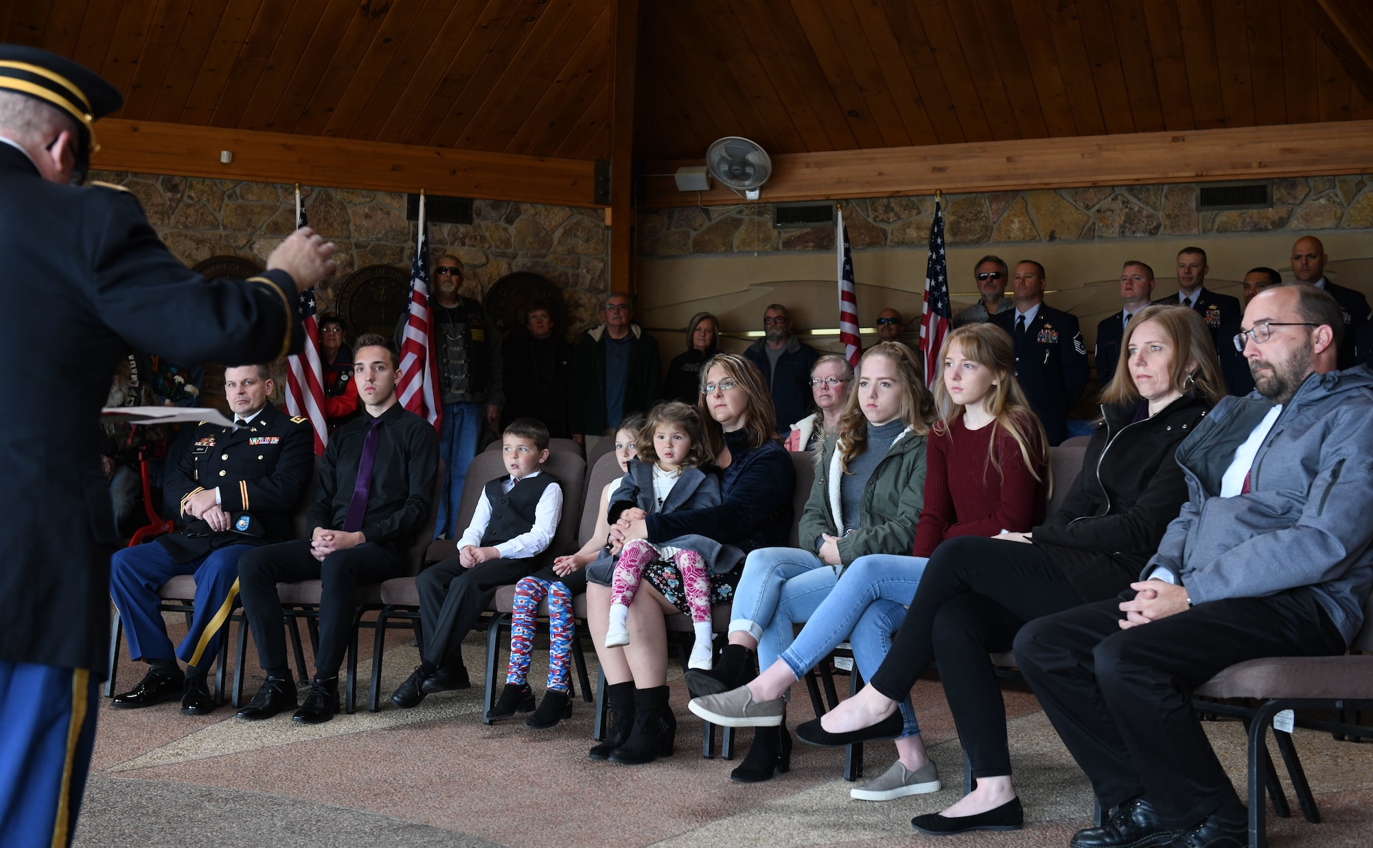 Family members attend a funeral service held in honor of former Pfc. Carroll E. Lonas before he is laid to rest at the Black Hills National cemetery in Sturgis, S.D., May 9, 2019. Lonas, 94, had served as rifleman with the U.S. Army National Guard’s 45th Infantry Division during World War II. Lonas was detained by the Germans for 14 months until he successfully escaped to friendly territory. (U.S. Air Force photo by Airman 1st Class Christina Bennett)