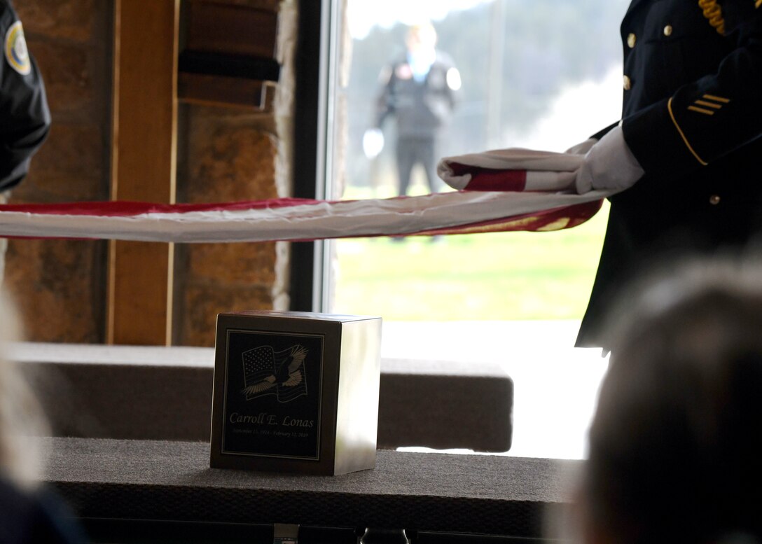 South Dakota Army National Guardsmen carefully fold a burial flag at the funeral of former Pfc. Carroll E. Lonas, at the Black Hills National Cemetery in Sturgis, S.D., May 9, 2019. Lonas spent 14 months as a German prisoner of war. He was almost executed on a firing line but was saved when an allied forces fighter plane flew by. (U.S. Air Force photo by Airman 1st Class Christina Bennett)