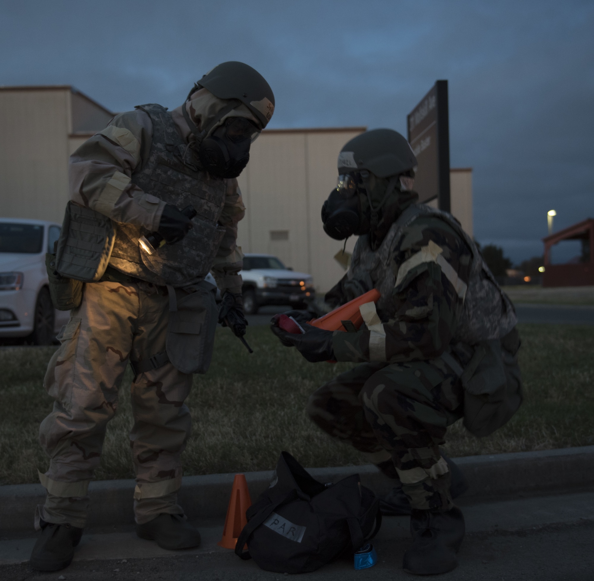 U.S. Air Force Senior Airman Charles Dungca, left, and Airman 1st Class Kelvin Powell, right, 60th Medical Group bioenvironmental specialists, perform a post attack reconnaissance sweep May 7, 2019, during a readiness exercise at Travis Air Force Base, California. The base conducted a week-long exercise to evaluate Travis’ ability to execute and sustain rapid global mobility operations. (U.S. Air Force photo by Staff Sgt. Amber Carter)