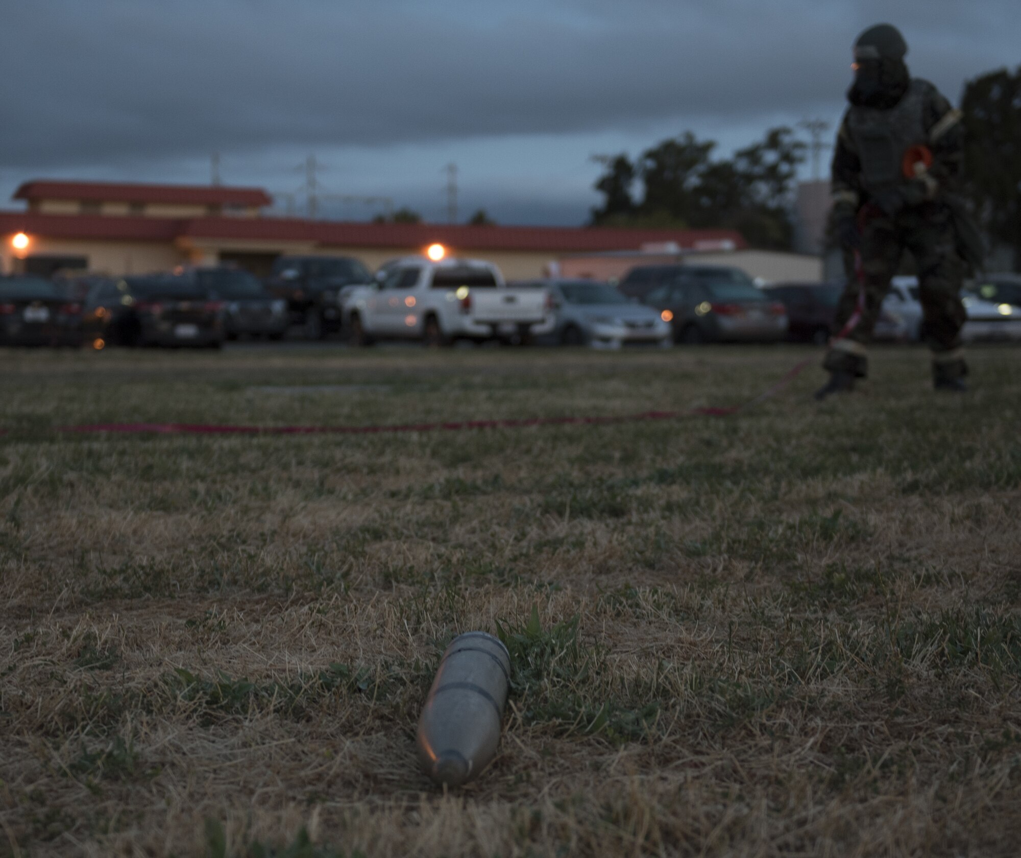 U.S. Air Force Airman 1st Class Kelvin Powell, 60th Medical Group bioenvironmental specialist, sets up a cordon around a fake projectile, May 7, 2019, during a readiness exercise at Travis Air Force Base, California. The base conducted a week-long exercise to evaluate Travis’ ability to execute and sustain rapid global mobility operations. (U.S. Air Force photo by Staff Sgt. Amber Carter)