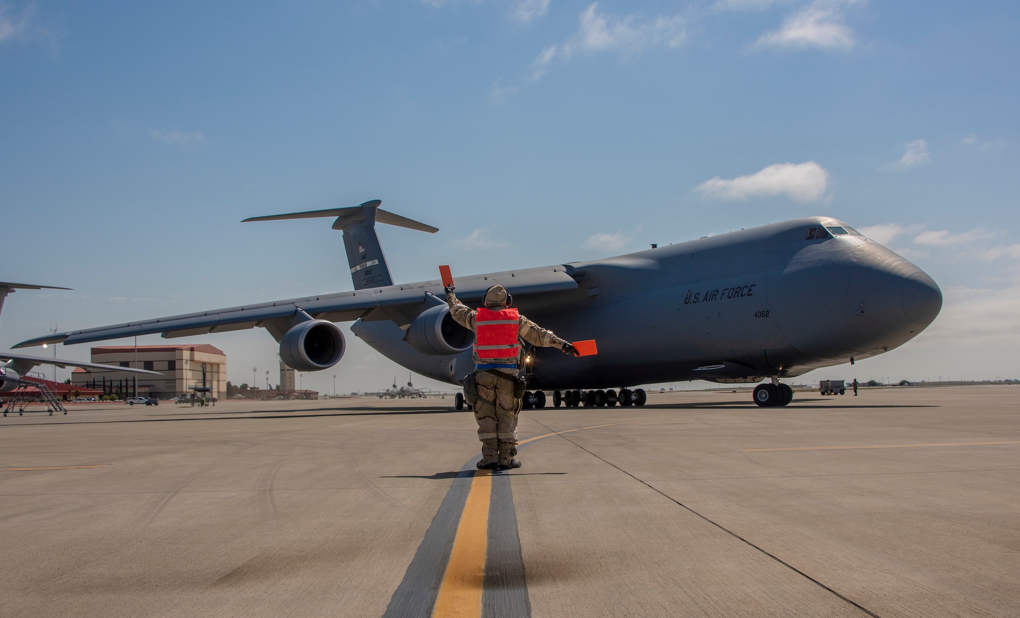 U.S. Air Force Staff Sgt. Corey Fugate, 349th Aircraft Maintenance Squadron marshals a C-5M Super Galaxy during a readiness exercise at Travis Air Force Base, California, May 9, 2019. The base conducted a week-long exercise that evaluated Travis’ readiness and ability to execute and sustain rapid global mobility around the world. (U.S. Air Force photo by Heide Couch)
