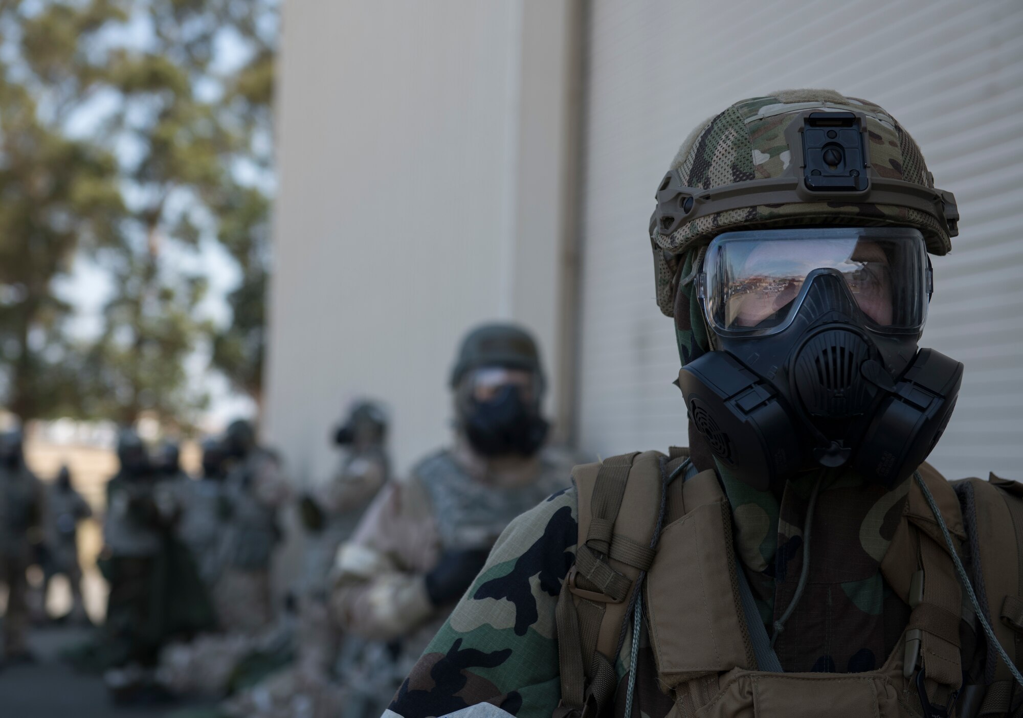Airmen assigned to the 60th Air Mobility Wing wait to be processed through simulated decontamination during a readiness exercise at Travis Air Force Base, California, May 9, 2019. The Airmen participated in a week-long exercise that evaluated the base’s readiness and ability to execute and sustain rapid global mobility around the world. (U.S. Air Force Photo by Airman 1st Class Amy Younger)